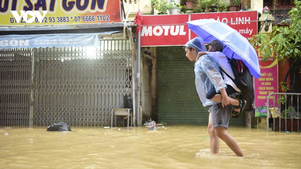 Students in Hanoi deal with rising floodwater levels